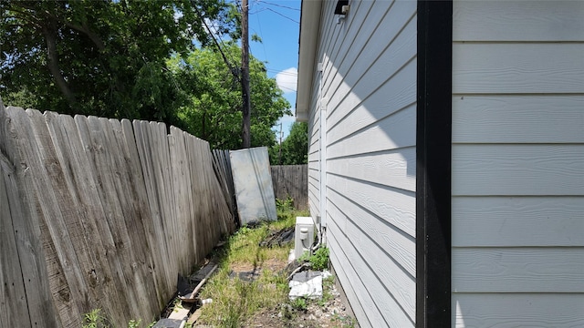 view of side of property featuring fence