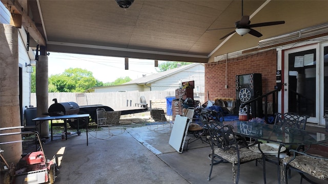 view of patio / terrace featuring fence, ceiling fan, and outdoor dining space