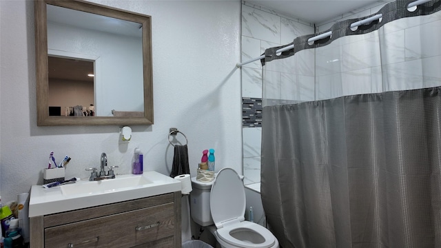 bathroom with vanity, a shower with shower curtain, and toilet