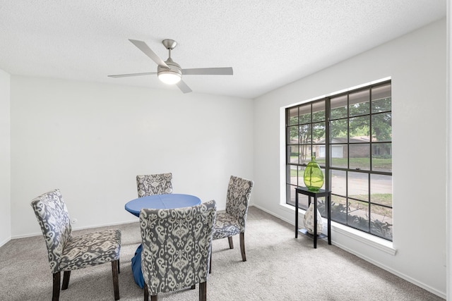 1710 Windsor Dr, Arlington, TX 76012 - carpeted dining area featuring a textured ceiling, ceiling fan, and baseboards