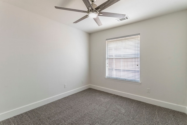 unfurnished room with dark colored carpet, baseboards, and ceiling fan