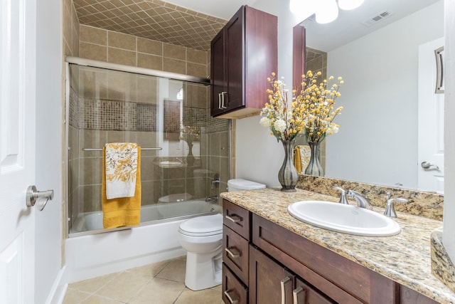 full bathroom with tile patterned floors, shower / bath combination with glass door, toilet, and vanity