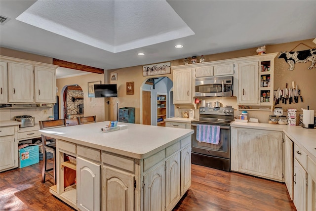 116 Nottingham Cir, Bridgeport, TX 76426 - kitchen with stainless steel microwave, electric range, arched walkways, open shelves, and recessed lighting