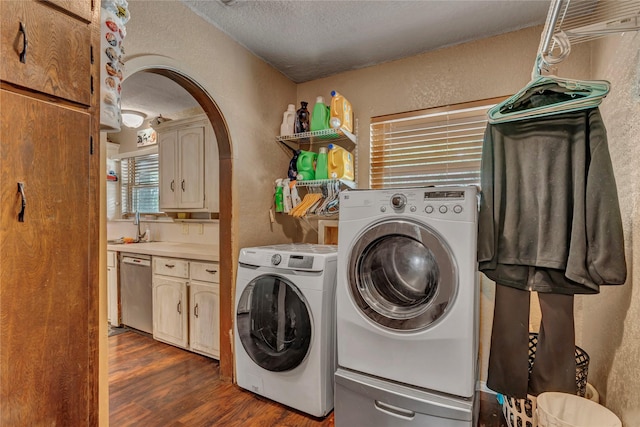 116 Nottingham Cir, Bridgeport, TX 76426 - washroom with a textured wall, washer and dryer, arched walkways, a textured ceiling, and dark wood-style flooring