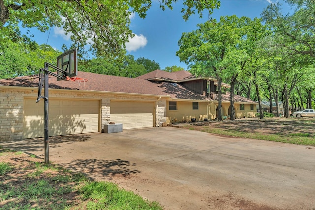 116 Nottingham Cir, Bridgeport, TX 76426 - view of front of property with driveway, an attached garage, and stone siding