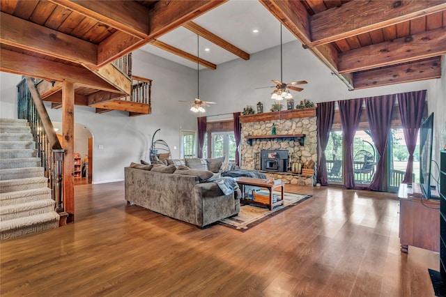 116 Nottingham Cir, Bridgeport, TX 76426 - living area featuring stairs, arched walkways, beamed ceiling, ceiling fan, and wood finished floors