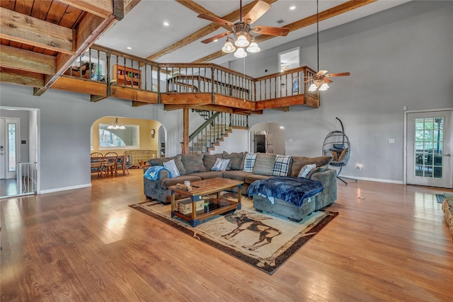 116 Nottingham Cir, Bridgeport, TX 76426 - living room featuring arched walkways, ceiling fan, a towering ceiling, stairway, and baseboards