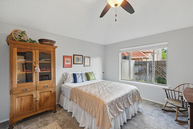 carpeted bedroom featuring vaulted ceiling, ceiling fan, and baseboards