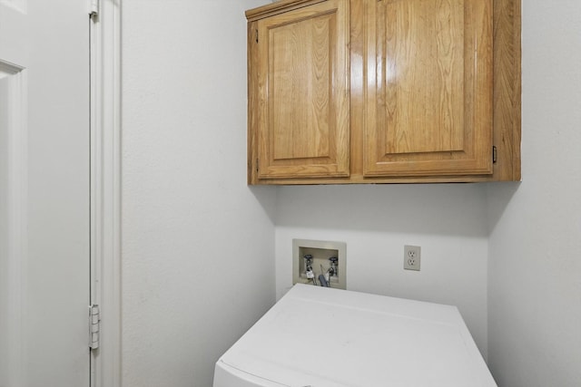 laundry area featuring cabinet space and washer / dryer