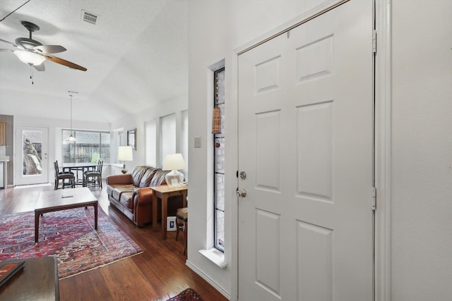 entryway with ceiling fan, dark wood-style floors, and lofted ceiling