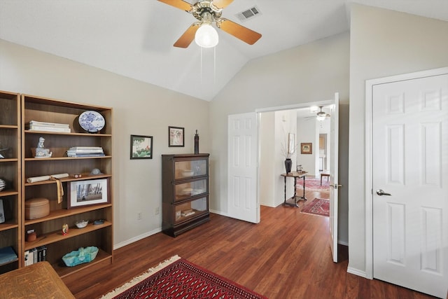 sitting room with ceiling fan, vaulted ceiling, dark wood-type flooring, and baseboards