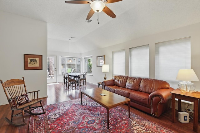 living area featuring ceiling fan, wood finished floors, vaulted ceiling, and baseboards