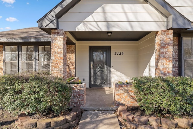 5129 Woodmeadow Ct, Garland, TX 75043 - entrance to property featuring covered porch and roof with shingles