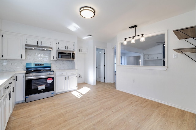 5129 Woodmeadow Ct, Garland, TX 75043 - kitchen featuring appliances with stainless steel finishes, backsplash, white cabinetry, light countertops, and vaulted ceiling