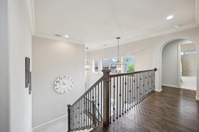 580 Butchart Dr, Prosper, TX 75078 - hallway featuring a chandelier, baseboards, crown molding, wood finished floors, and arched walkways