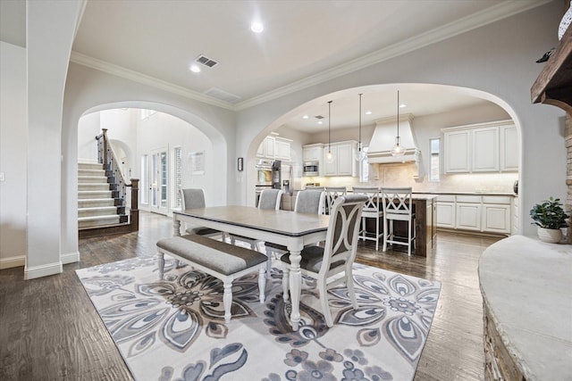 580 Butchart Dr, Prosper, TX 75078 - dining room featuring arched walkways, ornamental molding, wood finished floors, recessed lighting, and baseboards