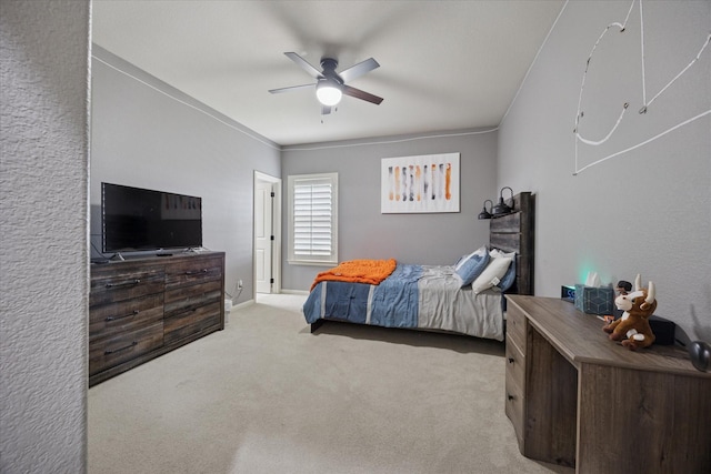 carpeted bedroom with a ceiling fan and baseboards