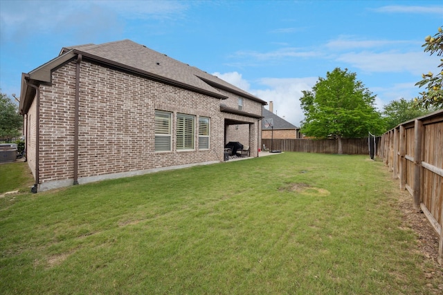 back of house featuring brick siding, a patio area, central air condition unit, and roof with shingles