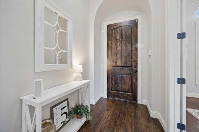 580 Butchart Dr, Prosper, TX 75078 - foyer with dark wood finished floors, baseboards, and arched walkways