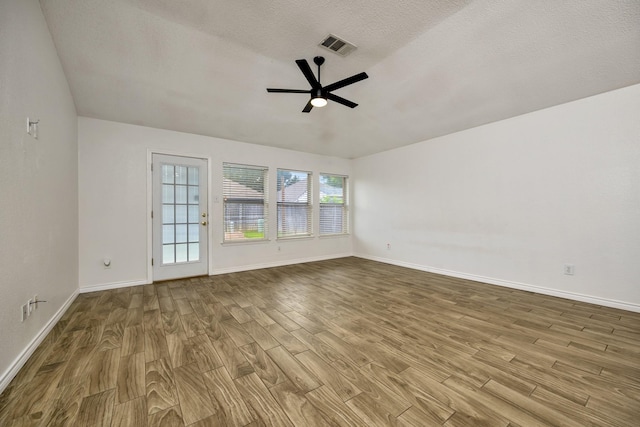 6717 Red Rock Trl, Watauga, TX 76137 - unfurnished room featuring wood finished floors, ceiling fan, baseboards, and a textured ceiling
