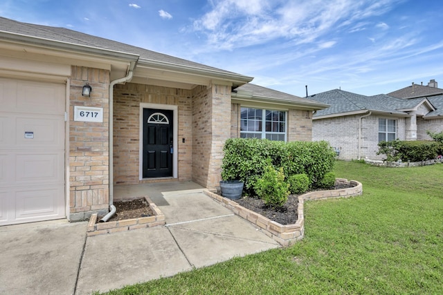 6717 Red Rock Trl, Watauga, TX 76137 - property entrance featuring a lawn, brick siding, a shingled roof, and a garage