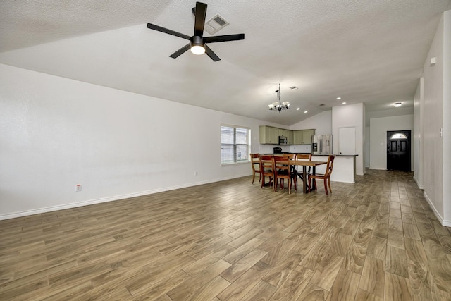 6717 Red Rock Trl, Watauga, TX 76137 - dining room with vaulted ceiling, light wood-style floors, a chandelier, ceiling fan, and baseboards