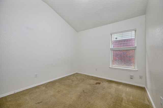 6717 Red Rock Trl, Watauga, TX 76137 - carpeted spare room featuring vaulted ceiling and baseboards