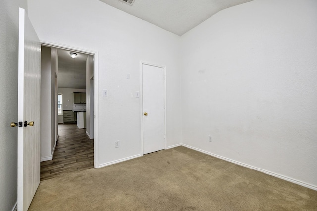 6717 Red Rock Trl, Watauga, TX 76137 - unfurnished bedroom featuring carpet, baseboards, and lofted ceiling