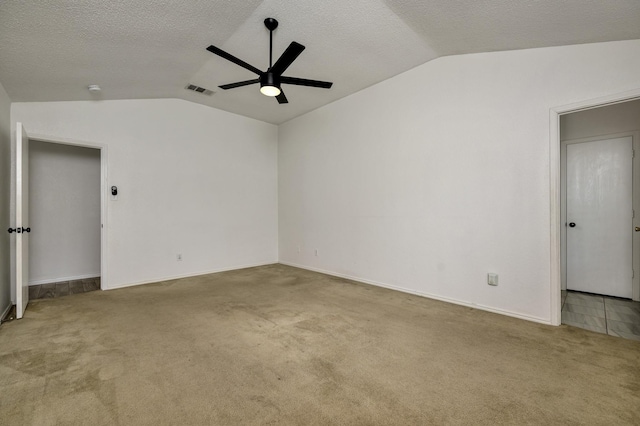 6717 Red Rock Trl, Watauga, TX 76137 - unfurnished room featuring lofted ceiling, ceiling fan, carpet floors, baseboards, and a textured ceiling