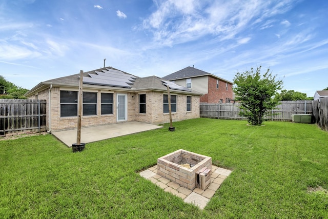 6717 Red Rock Trl, Watauga, TX 76137 - rear view of house featuring a patio, brick siding, solar panels, and a fire pit