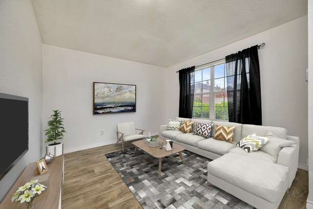 6717 Red Rock Trl, Watauga, TX 76137 - living room featuring wood finished floors, baseboards, and a textured ceiling