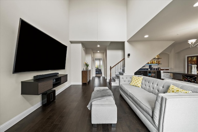 living area with dark wood-style flooring, baseboards, stairway, a chandelier, and recessed lighting