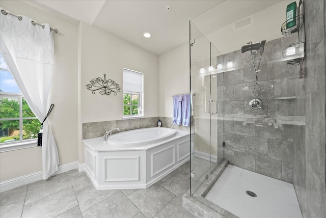 full bath featuring a stall shower, a bath, baseboards, and tile patterned floors