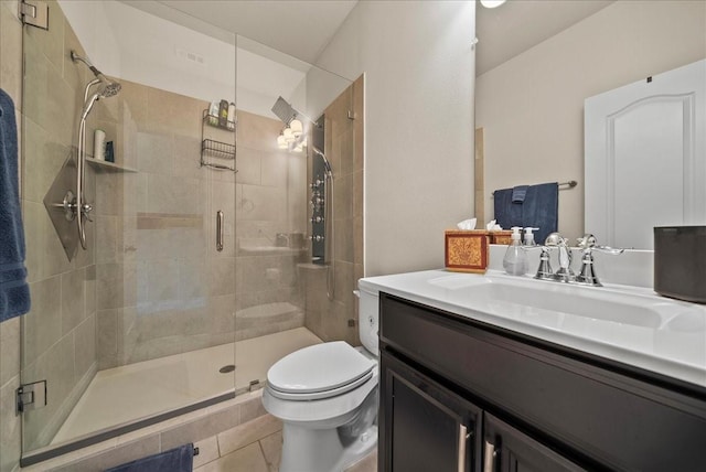 bathroom with toilet, a stall shower, vanity, and tile patterned flooring