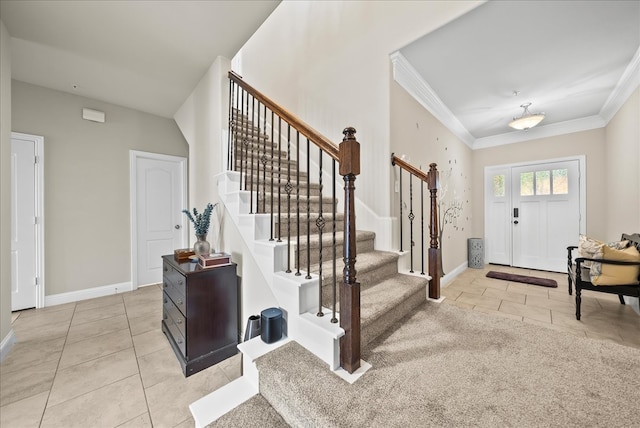 entryway featuring ornamental molding, tile patterned flooring, stairs, and baseboards