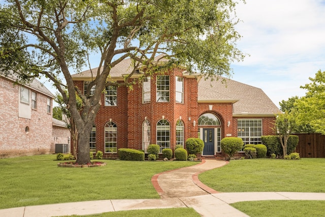 2830 Faversham Dr, Richardson, TX 75082 - colonial-style house featuring brick siding, a shingled roof, and central air condition unit