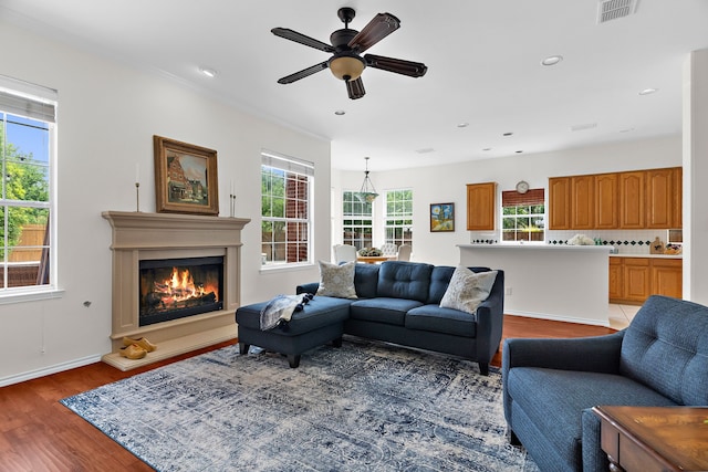 2830 Faversham Dr, Richardson, TX 75082 - living area featuring light wood-style flooring, a glass covered fireplace, ceiling fan, baseboards, and recessed lighting