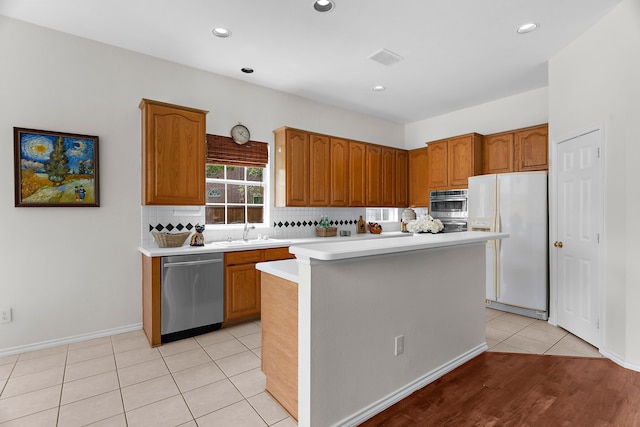 2830 Faversham Dr, Richardson, TX 75082 - kitchen with freestanding refrigerator, dishwasher, light countertops, a sink, and tasteful backsplash