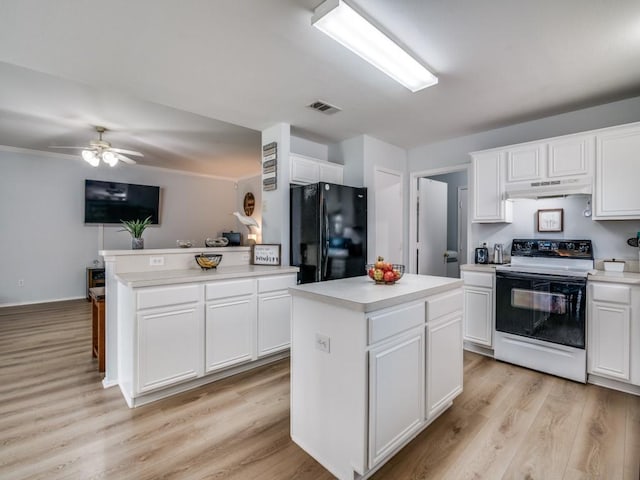 305 Rustic Meadows Dr, Royse City, TX 75189 - kitchen featuring electric stove, freestanding refrigerator, under cabinet range hood, a center island, and light wood-style flooring