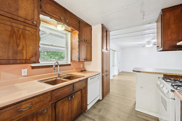 2115 Southridge Dr, Arlington, TX 76010 - kitchen with white appliances, a sink, light countertops, light wood-style floors, and a ceiling fan