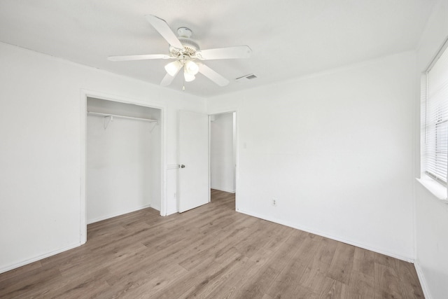 2115 Southridge Dr, Arlington, TX 76010 - unfurnished bedroom featuring a closet, wood finished floors, ceiling fan, and baseboards