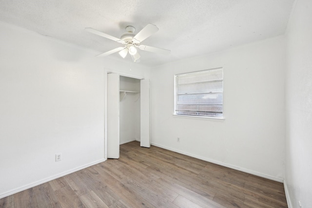 2115 Southridge Dr, Arlington, TX 76010 - unfurnished bedroom featuring wood finished floors, a closet, baseboards, and a ceiling fan