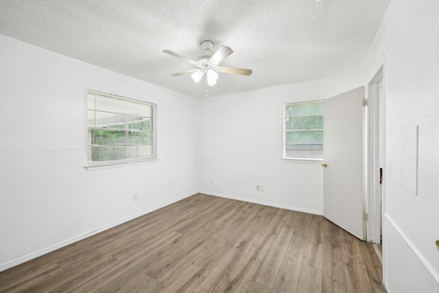 2115 Southridge Dr, Arlington, TX 76010 - empty room featuring wood finished floors, a textured ceiling, ceiling fan, and baseboards