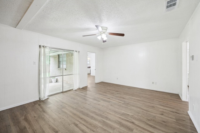 2115 Southridge Dr, Arlington, TX 76010 - unfurnished room with a ceiling fan, wood finished floors, and a textured ceiling