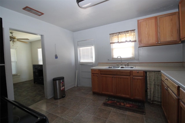 260 S Munday Ave, Munday, TX 76371 - kitchen featuring a sink, plenty of natural light, light countertops, and a ceiling fan