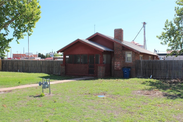 260 S Munday Ave, Munday, TX 76371 - back of house featuring brick siding and a chimney