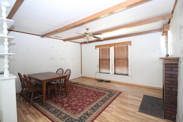 260 S Munday Ave, Munday, TX 76371 - dining space featuring beam ceiling, wood finished floors, ceiling fan, and baseboards
