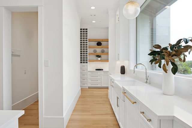 1405 Ridge Cir, Westlake, TX 76262 - bar with a sink, light wood-style flooring, recessed lighting, and baseboards