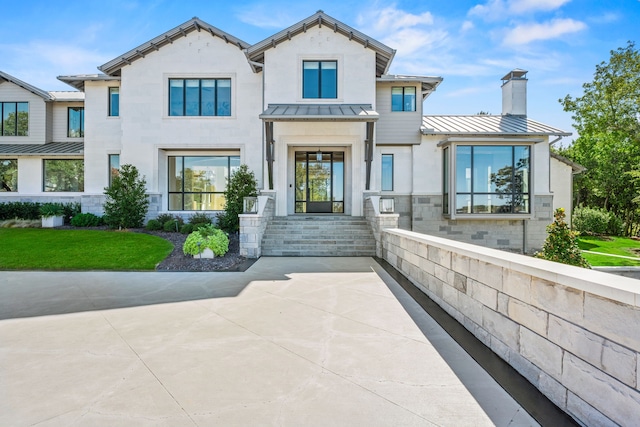 1405 Ridge Cir, Westlake, TX 76262 - view of front facade featuring a standing seam roof, a chimney, metal roof, stucco siding, and stone siding