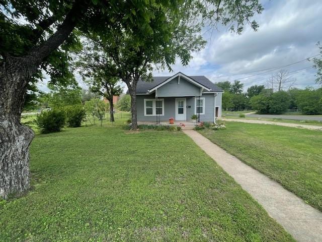bungalow-style home with a porch and a front lawn